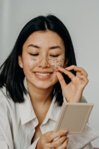 Mulher fazendo esfoliação facial. Em tipos de esfoliação para uma pele radiante.